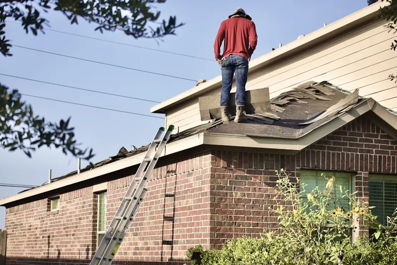 Professional roofer working on a residential roof in Mocksville